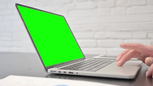 Senior Man Using Laptop with Green Screen