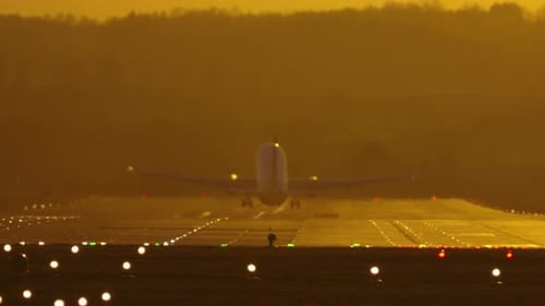 Airplane Taking Off into a Golden Sunrise