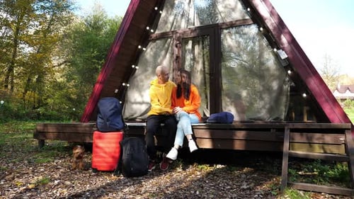 Couple Enjoying Cabin Vacation in Woods