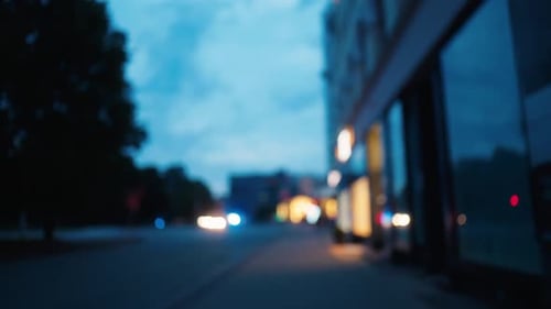 Stunning Evening Cityscape Featuring Blurred Streets and Beautiful Buildings Bathed in Soft Ambient