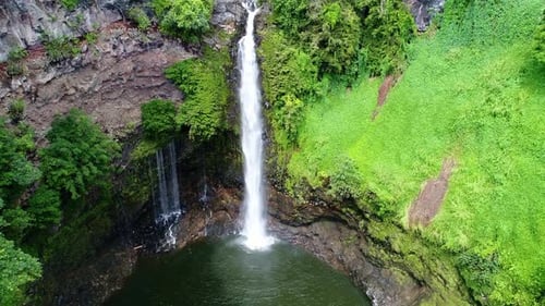 Water plunges down a river into another pool in rainforest - waterfall base