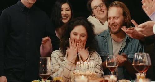 Friends Celebrate Birthday with Cake and Candles