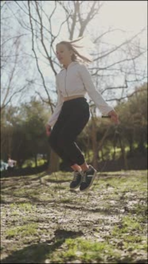 Young Woman Jumping Rope in a Park