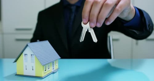 insurance of fire and theft .the hands of an insurer or real estate agent showing a house with fl