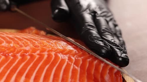 Cutting Fresh Salmon Fillet with Sharp Knife