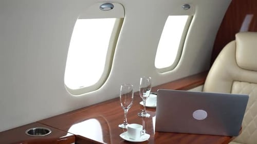 Luxury Private Jet Interior with Laptop and Champagne