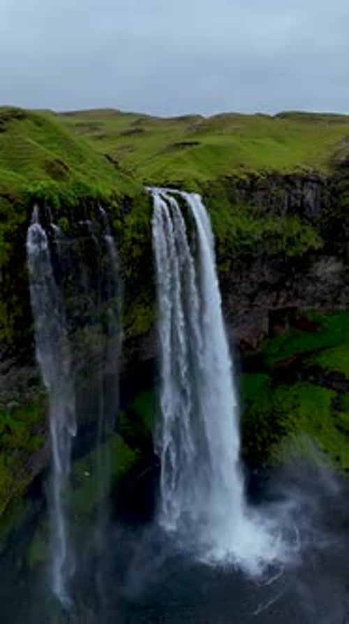 Majestic Seljalandsfoss Waterfall Cascading Down Cliffs in Icelands Lush Green Landscape