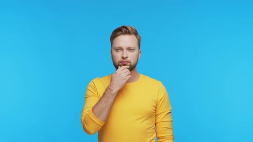 Thinking Young Man Over Vibrant Background Studio Portrait of Expressive Handsome Person