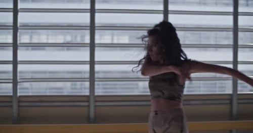 Woman Dancing Energetically in an Urban Space