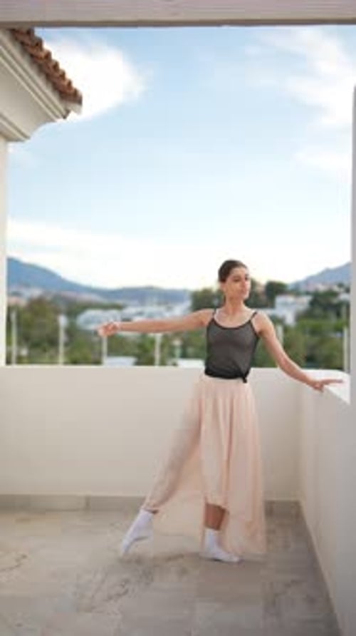 Bailarina de ballet que muestra movimientos elegantes en una elegante actuación en un balcón al aire libre