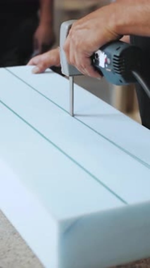 Vertical Video Rubber of a Man Cutting Foam Rubber for the Production of Armchairs Sofas at a