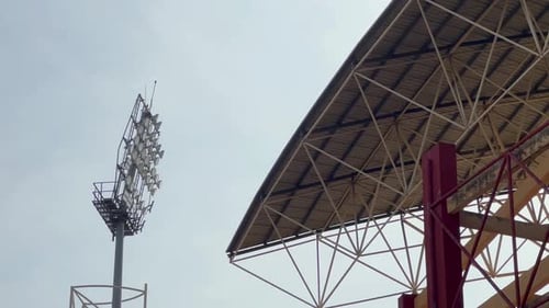 a powerful spot light near rooftop of a stadium