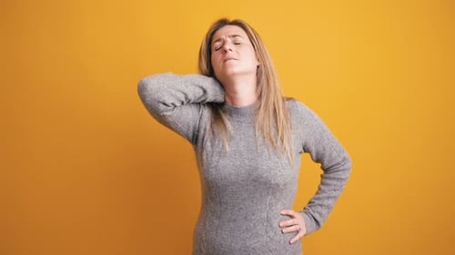 Woman Experiencing Neck Pain and Muscle Stiffness