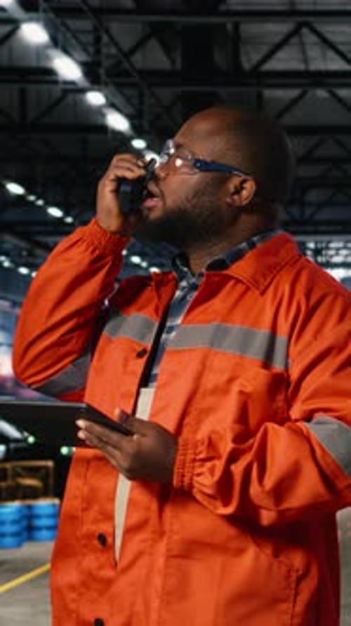 Vertical Video African American Professional Worker Using Walkie Talkie Radio in Industry Plant