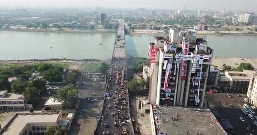 Vibrant Cityscape with Crowd on Bridge, Aerial View