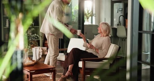 Senior Couple Relaxing Together With Coffee at Home