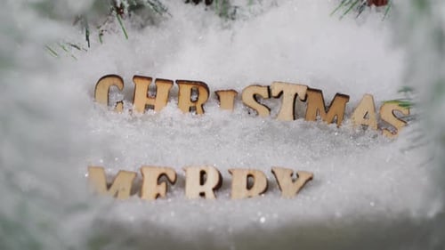 Merry Christmas Words in Snow Decoration Close Up