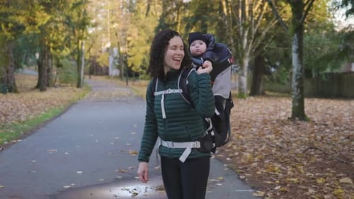Mother Walking in Suburban Neighborhood Baby in Carrier Fall Season Burnaby Vancouver BC Canada