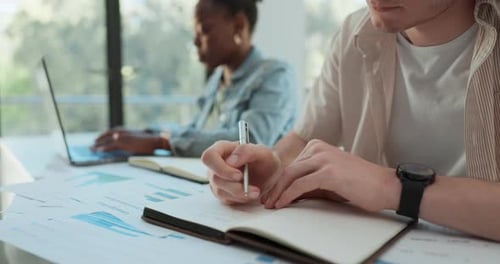 Man Taking Notes in Modern Office Setting