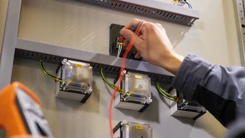 Engineer Measuring Voltage with a Multi Meter