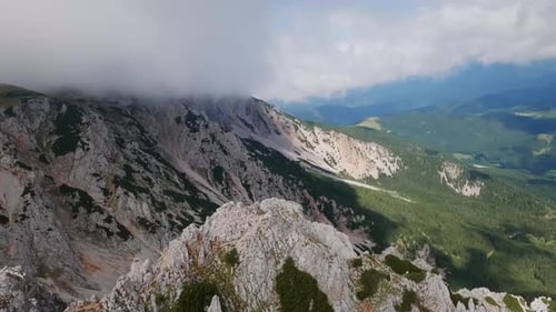 Flying on top of the hill with a FPV drone and entering a magnificent canyon. Flying very close to t