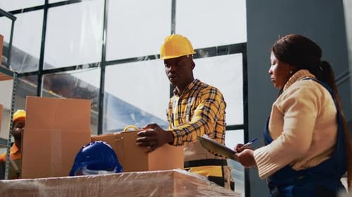 Workers Packing Boxes in a Shipping Warehouse