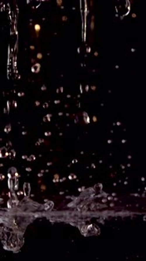 Water Drops Falling in Slow Motion on Black Background