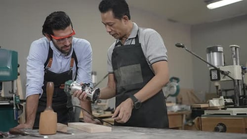 Carpenters are working together at workshop.