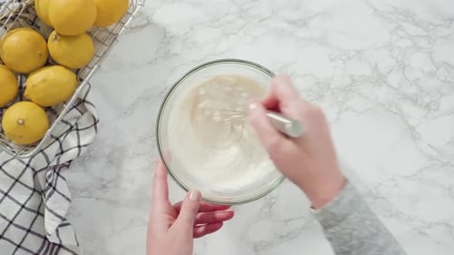 Step By Step Flat Lay Mixing Ingredients Into the Batter for Lemon Pound Cake