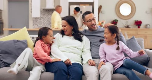 Happy Family Relaxing Together on Couch at Home