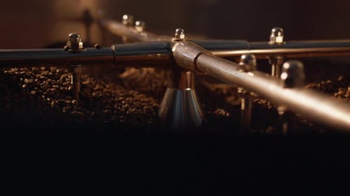Coffee beans mixing in roasting machine, workshop production