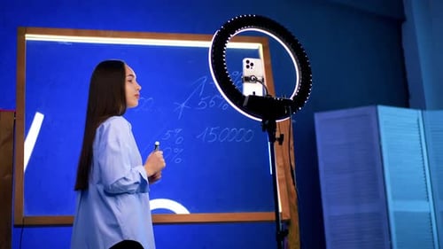 Woman with Marker Explaining Business Strategy on Video