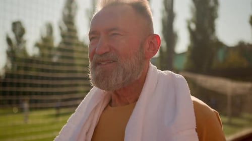 Close Up Caucasian European Elderly Man with Towel Neck Walk City Stadium Outside After Hard Sport