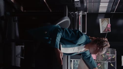 Woman Investigating Case Files in Office Setting