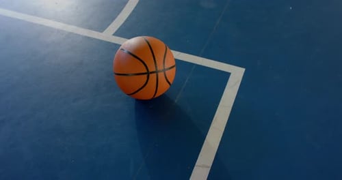 Basketball on court, ready for game or practice, sports equipment in gym, copy space