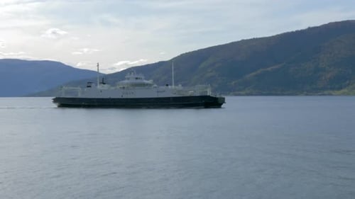 A Ferry Travels through a Fjord on a Sunny Summer Day in Norway