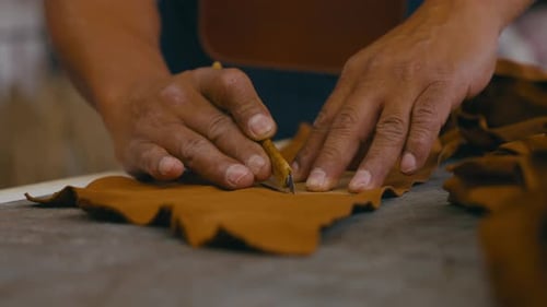 Artisan Shaping Leather with Cutting Tool Close Up