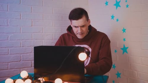 Young Frightened Man Sitting at Laptop