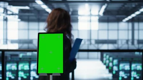 Close Up of Chroma Key Tablet Next to Coworkers Examining Data Center