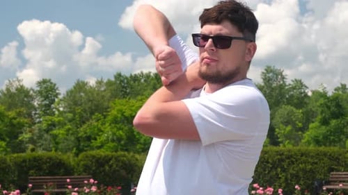 strong Caucasian man working out using kettlebell in the park