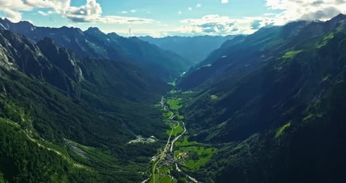 Drone Flies Over Green Picturesque Valley with Mountains in the Background High Mountains Famous