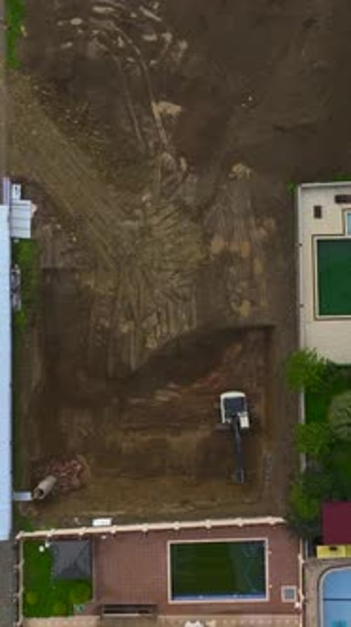 Vertical Video of Excavator Moving Soil From Foundation Pit Edge