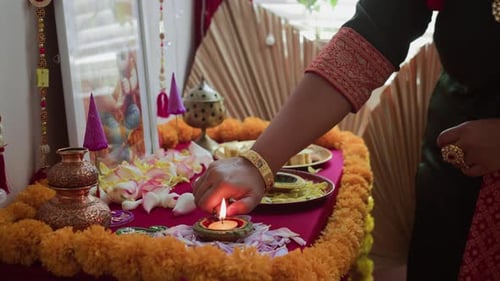 Unrecognizable Woman Lighting Candle on Diwali