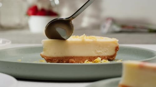 Spoon Cutting Piece of Delicious Cheesecake Dessert
