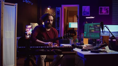 Adult Man Playing Guitar in Recording Studio