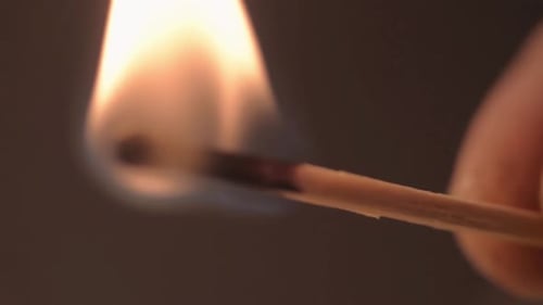 Burning Matchstick with Flickering Flame Close Up