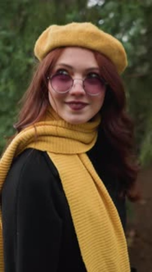 Stylish Woman Posing with Beret in Natural Setting