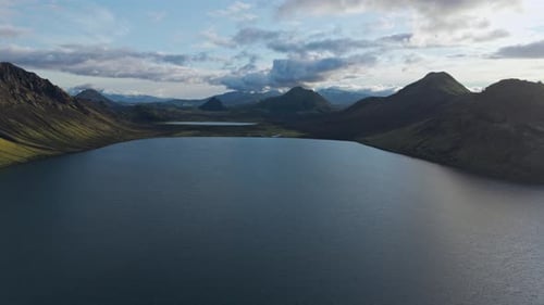 Breathtaking Aerial View of Vast Mountain Lake Under Dramatic Skies