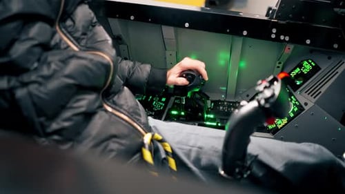 close-up of the cockpit of a military plane a pilot with a steering wheel and many buttons