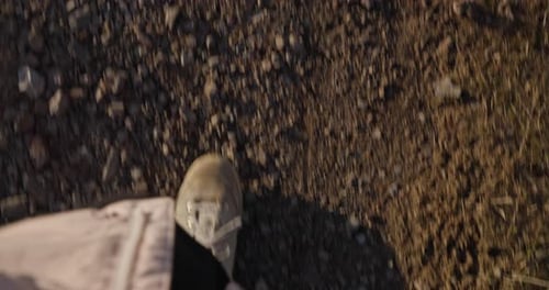Person Steps with Her Hiking Boots on a Dirt Path During a Hike Outside of Urban Areas Hiking on a